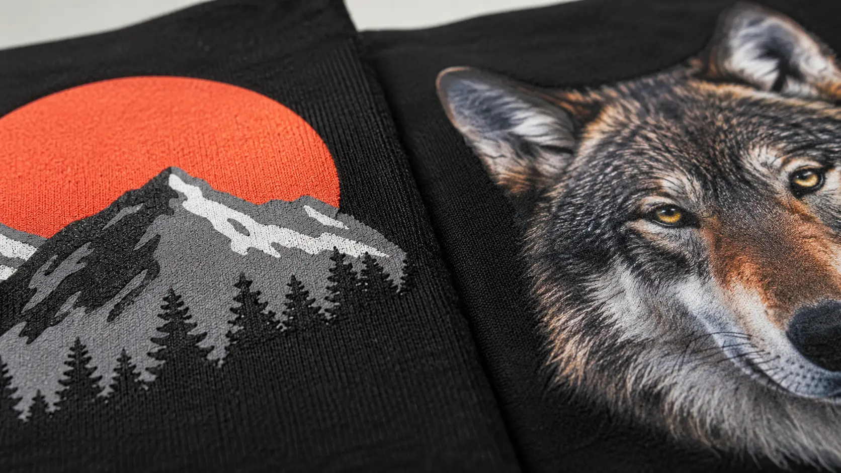 Close-up comparison of a full-color DTF transfer print next to a spot-color screen print on dark fabric